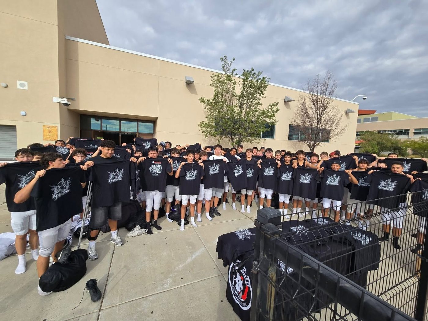 Sponsored team holding up their Unleashed shirts